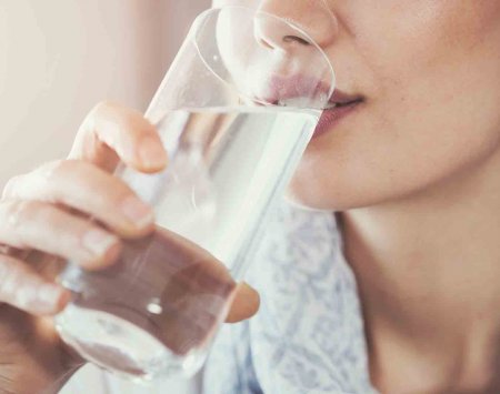 Une femme en train de boire de l'eau